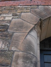 Close up of sandstone arch surrounding door
